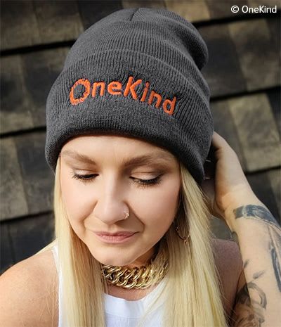 OneKind fundraiser Lauren wearing OneKind beanie hat.