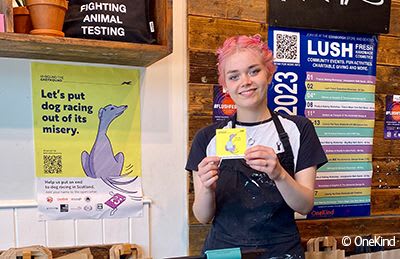 Shop worker in Lush helping with OneKind greyhound campaign