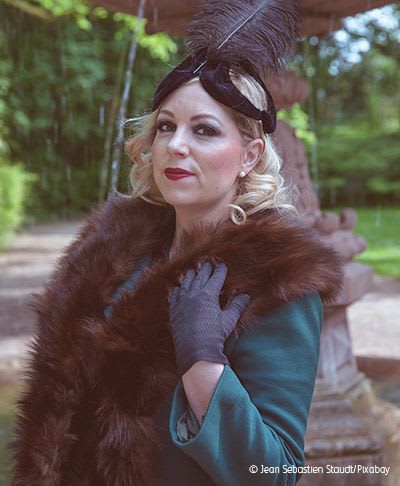 Woman wearing vintage clothing including fur stole.
